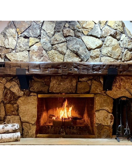 Norfolk Farmhouse Bracket by Industrial Farm Co supporting rustic wood mantel on stone fireplace with metal brackets and h...