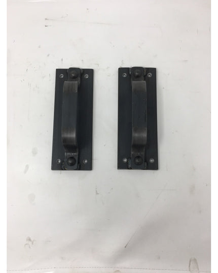 Two black metal Corning Handle door pulls by Industrial Farm Co mounted on white wall, featuring rectangular backplates an...