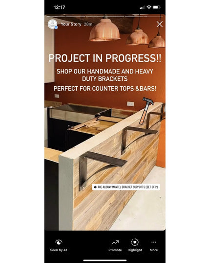 Industrial black steel mantel brackets supporting reclaimed wood bar counter during construction, featuring curved support...