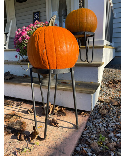 Black metal raised planter stands holding orange pumpkins on front porch steps with mums and autumn decorations - The Dori...