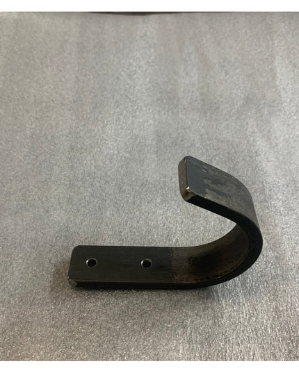 Black metal curved wall hook with two mounting holes from Industrial Farm Co, The Kinnley 1 inch wide design on gray surface