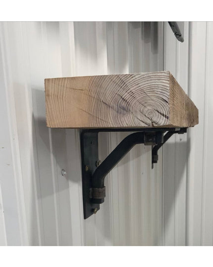 Black metal Rosamond shelf bracket supporting rustic wood beam shelf mounted on white wall, Industrial Farm Co decorative ...