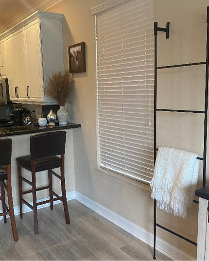 Black metal Brielle Top Mounted Blanket Ladder by Industrial Farm Co displayed in modern kitchen with white throw blanket