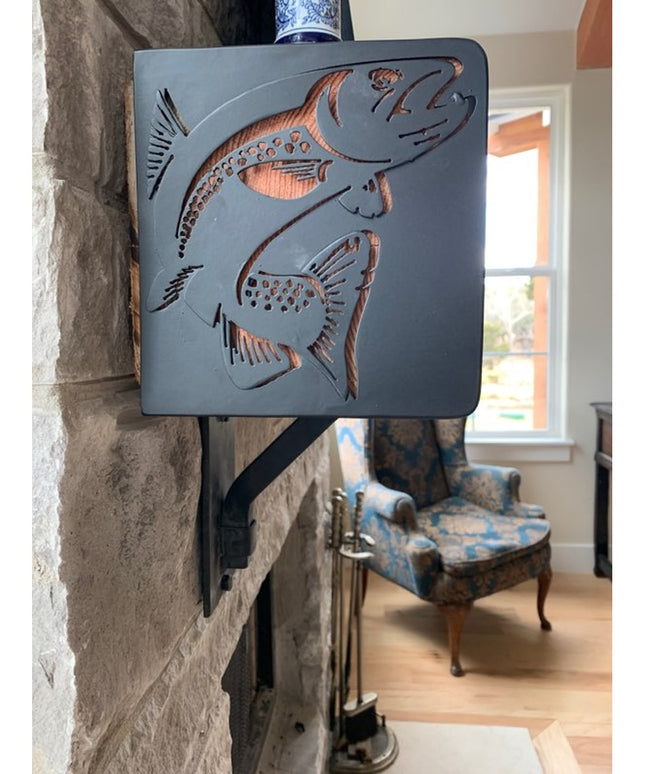 Vandiver Trout Mantel End Caps by Industrial Farm Co in dark gray metal with decorative cutout fish design mounted on ston...