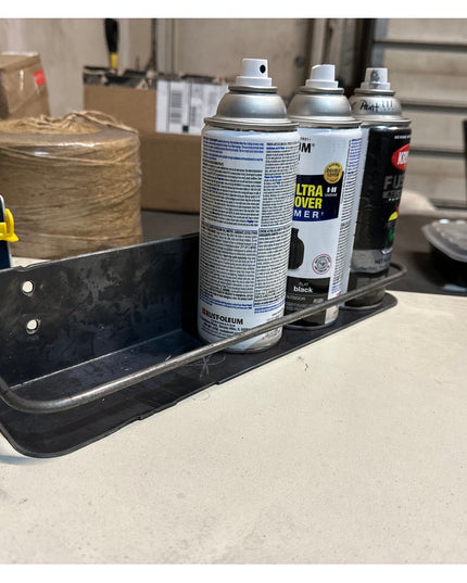 Matte black metal wall mounted shelf holding spray paint cans in workshop setting - Industrial Farm Co Herdon kitchen spic...