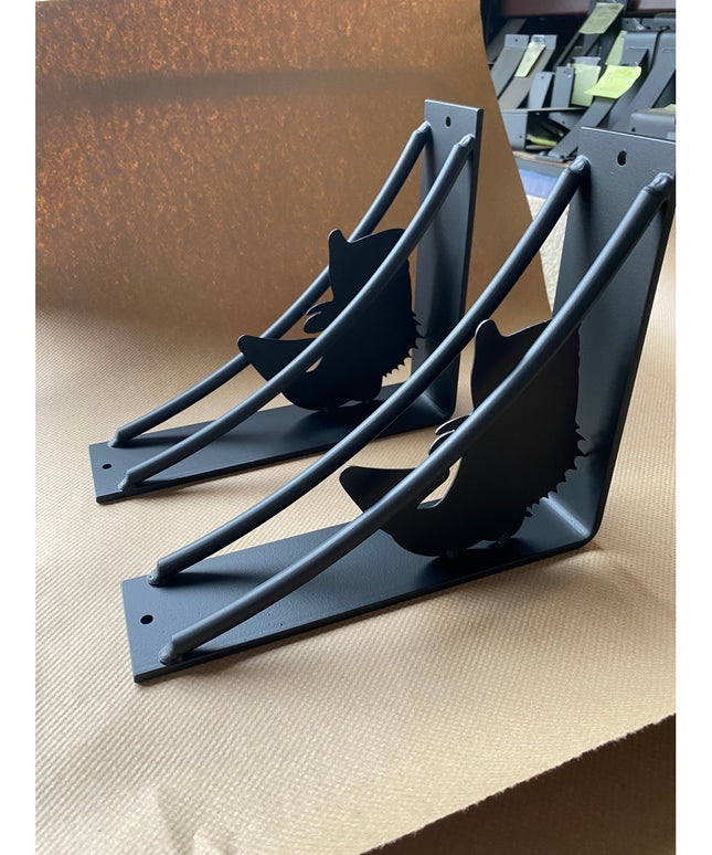 Black metal shelf brackets with large mouth bass fish silhouette cutouts from Industrial Farm Co, showing heavy-duty trian...