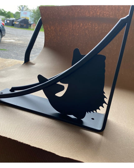 Black metal shelf bracket featuring large mouth bass fish silhouette design, heavy-duty construction with mounting holes, ...