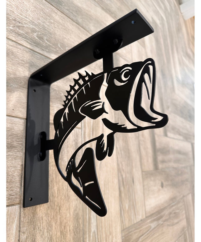 Black metal shelf bracket with decorative bass fish cutout design by Industrial Farm Co, mounted on light wood background