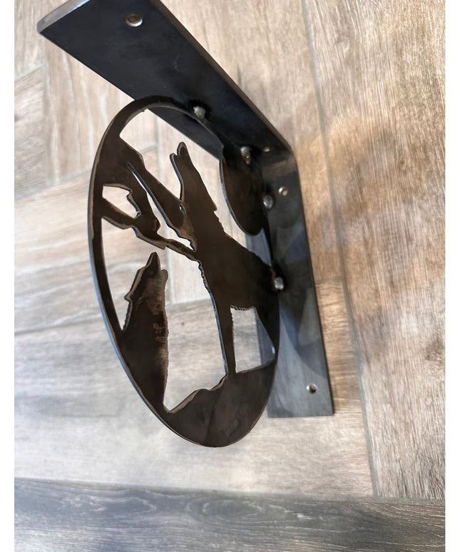 Black metal wolf silhouette shelf bracket by Industrial Farm Co showing handcrafted decorative support on wood surface