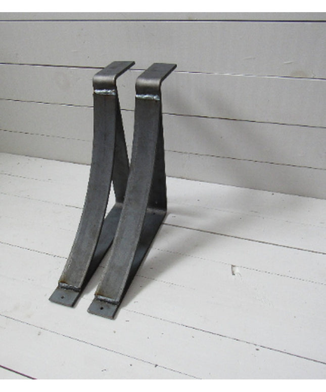 Two black metal Marietta Shelf and Mantle Support brackets by Industrial Farm Co displayed against white wooden planks, sh...