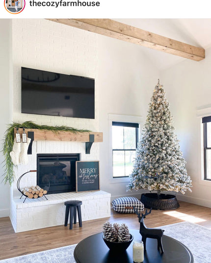 Living room with Christmas tree, fireplace, and TV in a cozy farmhouse setting.