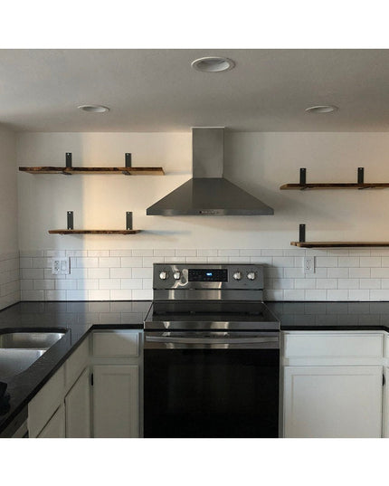 Black metal Lucas L Bracket shelf supports holding rustic wood shelves in modern white kitchen with subway tile backsplash...