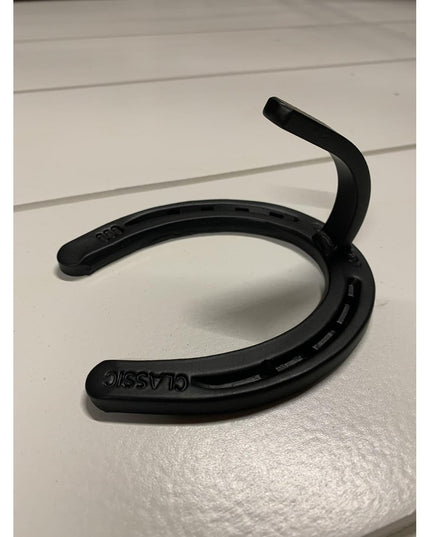 Black heavy duty horseshoe wall hook by Industrial Farm Co, handmade metal farmhouse decor with curved design on white sur...
