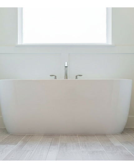 Oswego Modern Bathroom Towel Bar by Industrial Farm Co mounted on white bathroom wall above freestanding white bathtub