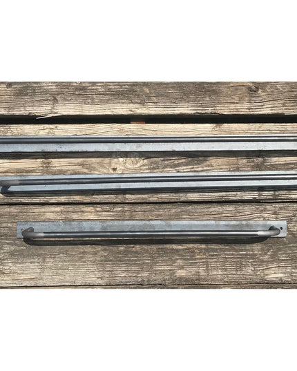 Three Oswego Modern Bathroom Towel Bars in brushed gunmetal finish displayed on weathered wood background, showing differe...