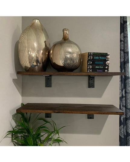 Black steel Industrial Farm Co Owasco L shelf brackets supporting rustic wood floating shelves with decorative glass vases...