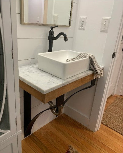 Industrial Farm Co Rochester black metal countertop support brackets holding floating wood vanity with white vessel sink a...