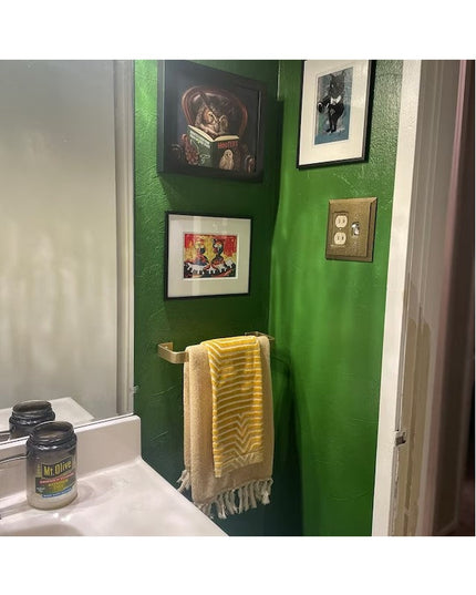 Brass Emma Towel Holder door handle by Industrial Farm Co mounted on green bathroom wall holding yellow striped towel