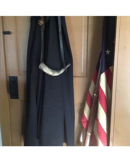 Dark navy blue door with white horn-shaped Corning Handle door pull by Industrial Farm Co, American flag visible on right ...