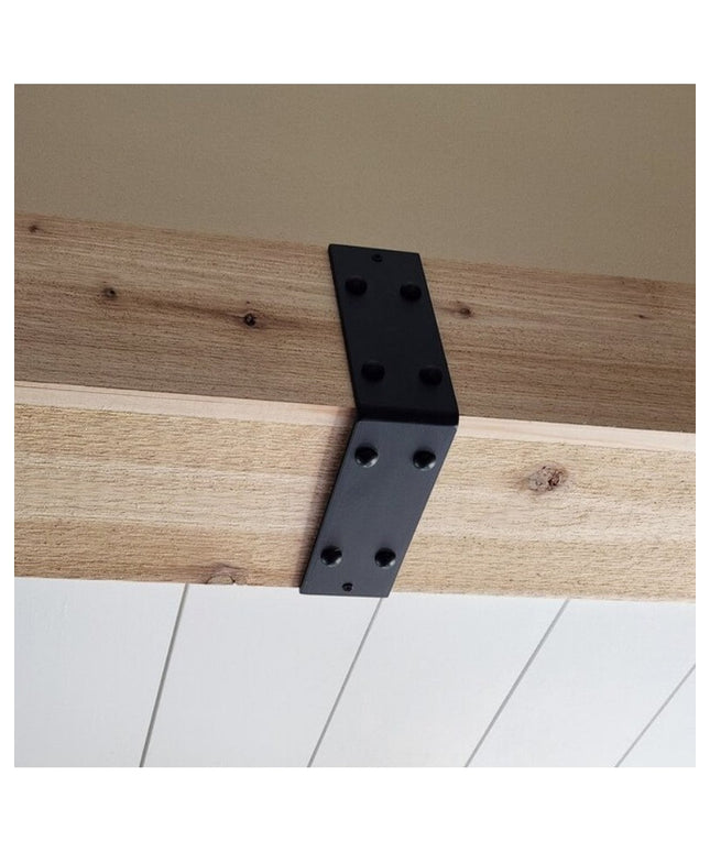 Black metal L-shaped beam strap bracket mounted on natural wood ceiling beam with white shiplap wall below - The Billings ...