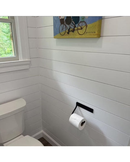 Howlett Hill black metal toilet paper holder mounted on white shiplap wall in modern farmhouse bathroom by Industrial Farm Co