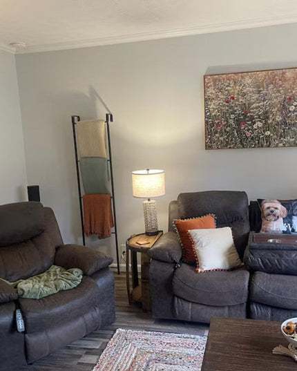 Black metal Hal Standing Mounted Blanket Ladder by Industrial Farm Co displaying colorful throw blankets in modern living ...