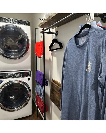 Black metal standing blanket ladder mounted between washer and dryer in laundry room holding colorful towels and clothing ...