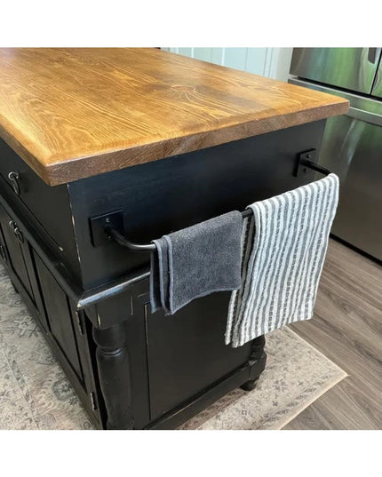 Industrial Farm Co Split Rock black metal towel rack mounted on kitchen island with wood countertop holding striped and so...