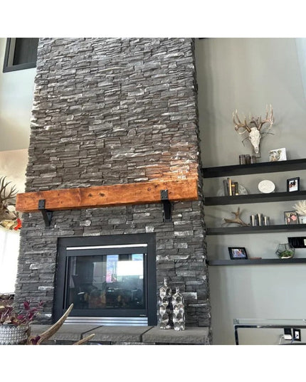 Heavy duty steel Spafford mantel brackets with rivets supporting reclaimed wood beam on gray stacked stone fireplace by In...