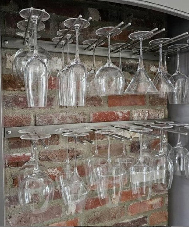 White Plains Wine Glass Rack by Industrial Farm Co displaying clear wine glasses hanging upside down in rustic brick cabin...