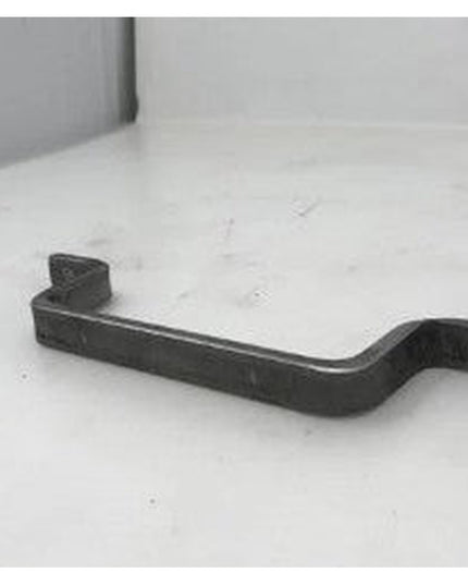 Black wrought iron Onondaga Handle door pull by Industrial Farm Co with curved design and mounting hardware on white surface