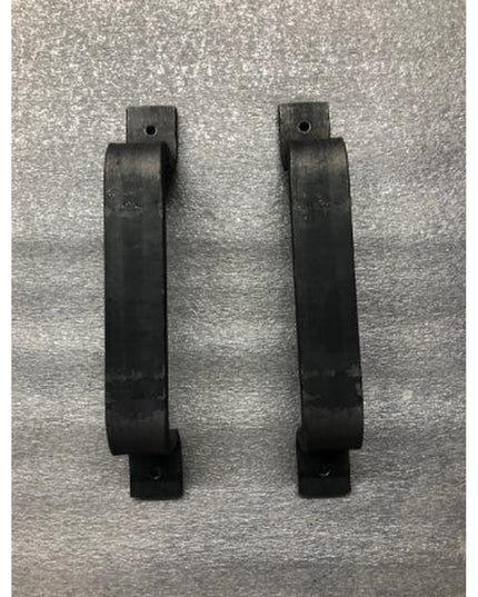 Two black metal Sagamore Hill Pull door handles by Industrial Farm Co displayed on textured gray surface, showing modern i...