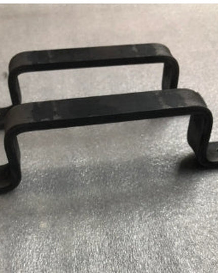 Black metal Sagamore Hill Pull door handle by Industrial Farm Co with curved rectangular design and mounting plates on gra...