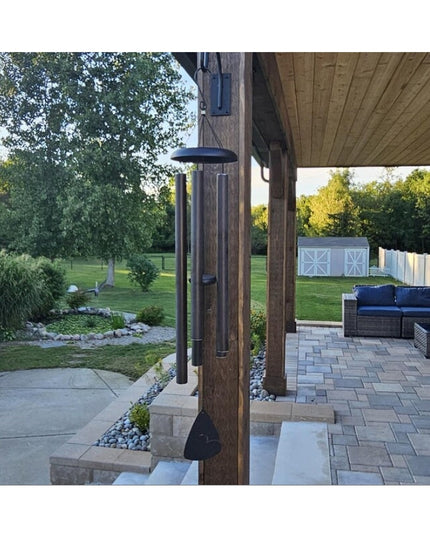 Industrial Farm Co Gregory Shepherd Hook in black metal hanging from wooden porch post with wind chimes on covered patio