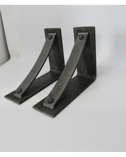 Two black metal Troy Shelf Support brackets by Industrial Farm Co with triangular design and mounting holes on white backg...