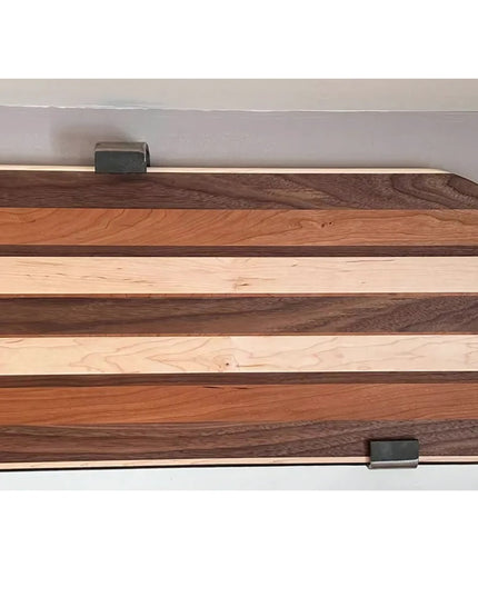 Earl Style J black metal shelf brackets supporting natural wood floating shelves with mixed grain patterns against white wall