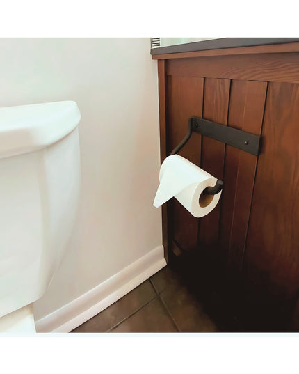 Howlett Hill black metal toilet paper holder mounted on wood cabinet next to white toilet in bathroom by Industrial Farm Co