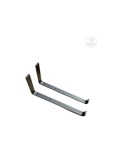 Two dark bronze metal Earl Style J Shelf Brackets by Industrial Farm Co with curved support arms and mounting holes on whi...