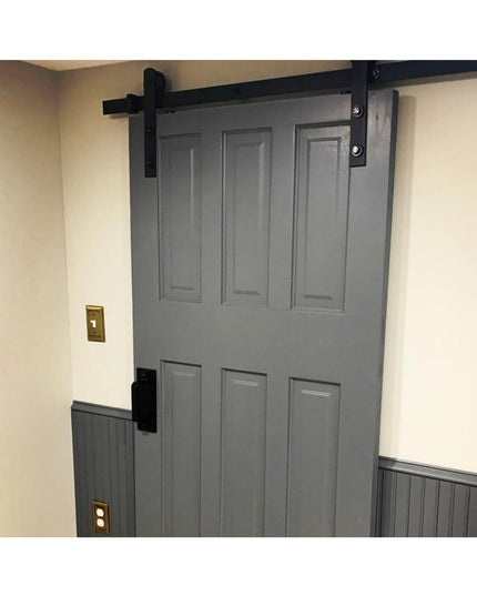 Black metal Corning Handle door pull mounted on gray sliding barn door with black hardware track system by Industrial Farm Co