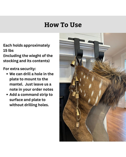 Brown fur Christmas stocking with gold bells hanging from black metal Industrial Farm Co Annie Stocking Holders mounted on...