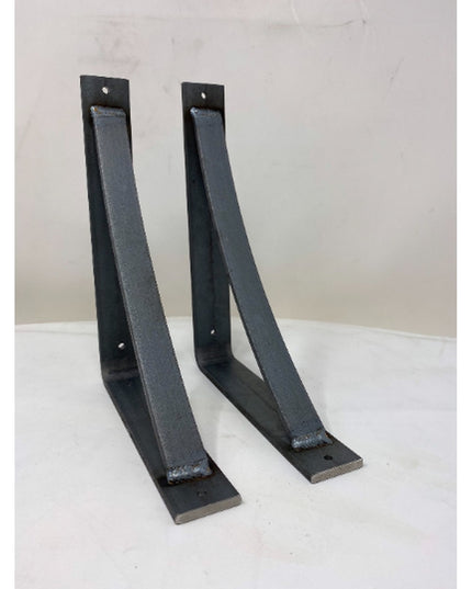 Two black metal curved shelf brackets from Industrial Farm Co, The Rey Bracket Support, with mounting holes displayed on w...