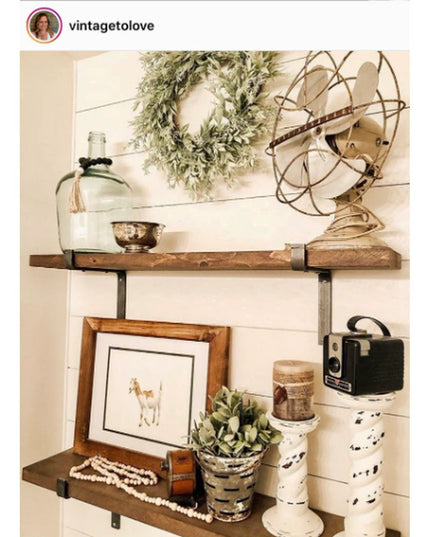 Rustic wood shelves with black metal Z-style brackets displaying vintage decor items including wreath, fan, glass jug and ...
