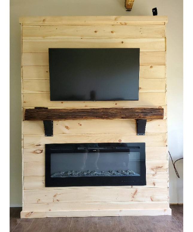 Black metal Tipp Hill Mantel Support brackets holding rustic wood beam on light pine shiplap fireplace wall with mounted T...