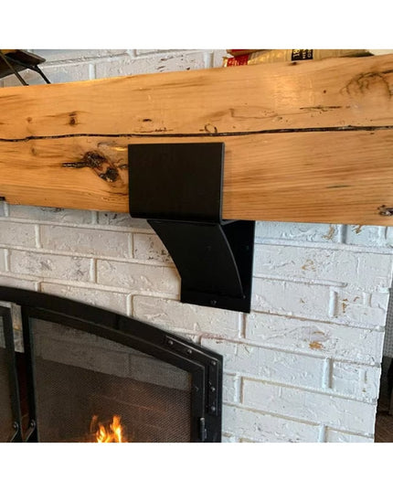 Black metal Otisco Farmhouse Style Bracket supporting rustic wood beam mantel above white brick fireplace from Industrial ...
