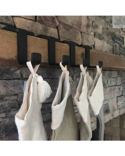 Industrial Farm Co Annie Stocking Holder with black metal hooks mounted on rustic wood beam, displaying cream and burlap C...