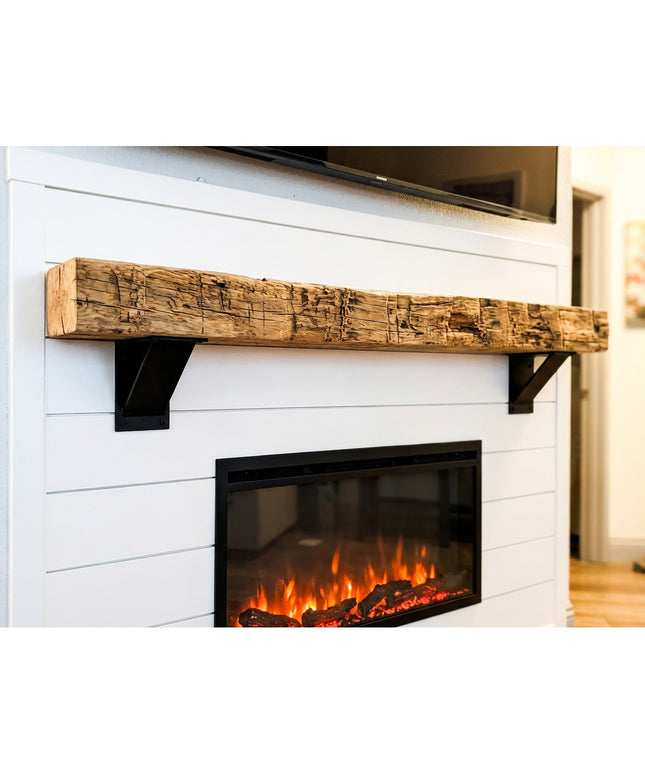 Heavy duty black steel industrial shelf brackets supporting rustic reclaimed wood mantel above white shiplap electric fire...
