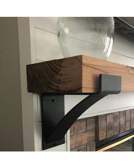 Kudlick Farmhouse Mantel Bracket in dark wood with black metal support holding glass vase on white fireplace mantel by Ind...