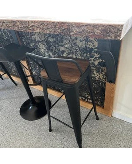 Black metal Rochester countertop support brackets by Industrial Farm Co holding up granite counter with bar stools underneath