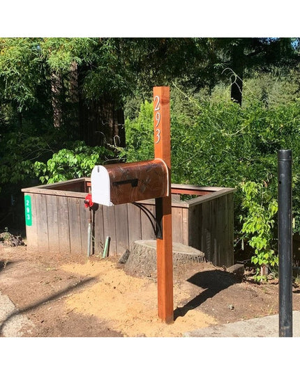 Industrial Farm Co Sawmiller black iron shelf bracket mounted on white shiplap wall supporting natural wood shelf with dec...