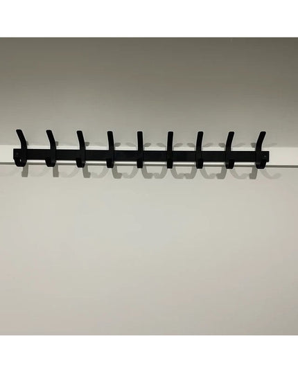 Black metal Christopher Double Hook Coat Rack by Industrial Farm Co with 9 wall-mounted hooks against white wall